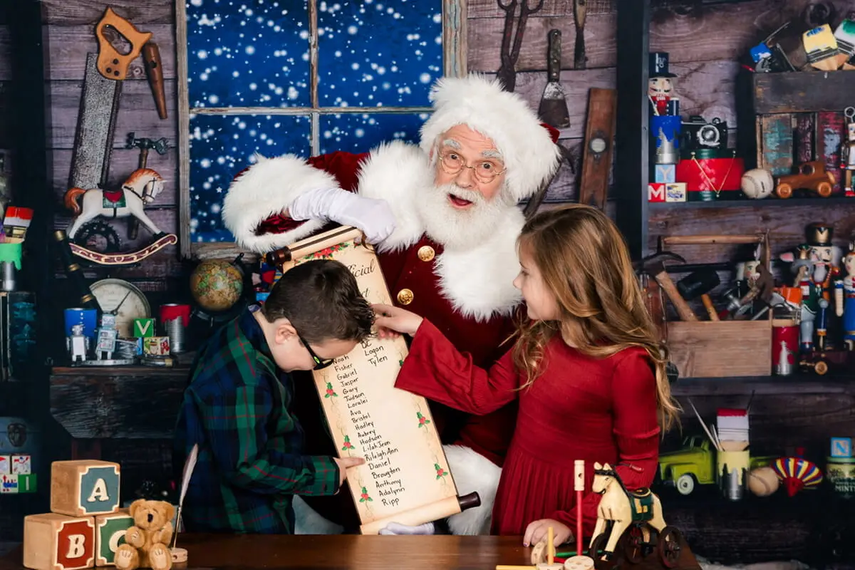 Santa with children and a Christmas list.