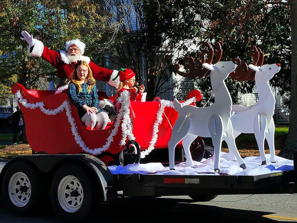 Santa on sleigh with reindeer float.