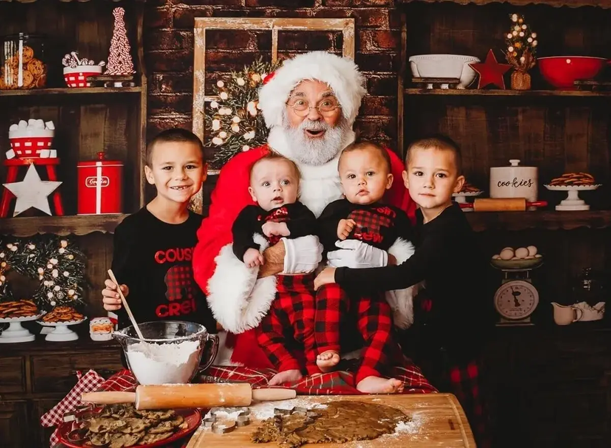 Santa with children in a festive kitchen.